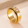 Anillo giratorio de comercio exterior transfronterizo, anillo de acero inoxidable con flor de goteo de aceite moderno y único, anillo de cruz giratorio