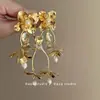 Pendientes de borlas con flores doradas de estilo chino, hojas rotas bañadas en oro, elegantes y retro de alta gama, de estilo nacional.