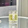 Conjunto de copos de vidro resistentes ao calor para uso doméstico, apresentando um design simples, moderno e elegante, incluindo copos de vidro, copos de água e taças de vinho, todos em cor transparente