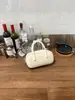 Elegante bolsa de boliche de mano para mujer, nuevo bolso de hombro de moda primavera/verano 2026, bolso cruzado versátil para el trabajo