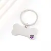 Colgante de pata de perro para mascotas transfronterizo con diseño de goteo de aceite, material en blanco de acero inoxidable, placa de identificación de perro de hueso grabada con láser, llavero de metal
