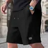 Shorts casuais de waffle masculinos de verão transfronteiriços com cordão na cintura elástica, shorts de praia folgados com bolsos e patch de logo, shorts de comprimento até o joelho