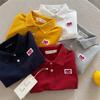Polo para Niños 2026 Ojos Entrecerrados Verano Nuevo Producto Niños y Niñas Polo de Manga Corta con Forma de Corazón Camiseta Estilo Japonés para Bebé con Cuello Campana