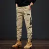 Pantalones de trabajo multi-bolsillo texturizados de algodón de fibra larga de alta densidad para hombre, corte holgado retro, color café, pantalones casuales funcionales tácticos de alta calle