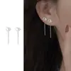 Pendientes asimétricos de estrella de cuatro puntas para mujer, elegantes y a la moda, con cadena de viento frío.