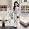Conjunto de Dos Piezas de Camiseta Casual Fina de Manga Corta Nueva Tendencia Verano 2026 y Pantalones de Pierna Ancha de Encaje Únicos para Niñas
