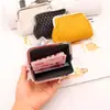 Spot atacado fornecimento transfronteiriço porta-moedas feminino com fivela bolsa com clipe de 4 polegadas bolsa de cartão trançada PU bolsa de mão