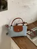 2026 Nuevo Estilo Fresco Lunares Personalidad Elegante Patchwork Bolso de Hombro Relajado Bolso Cubo Moderno Bolso de Hombro para Viajes