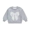 Sudadera para niña de comercio exterior 2026 nueva elegante infantil primavera moda versátil conjunto de primavera para bebé con lazo