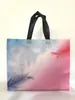 Bolsa no tejida de color spot recubierta con prensado en caliente bolsa de regalo publicitaria bolsa de compras de ropa no tejida portátil impresión de logotipo
