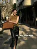 Falda midi de cuero para mujer Shenzhen Nanyou, de cintura alta, con abertura, recta, adecuada para ir al trabajo, elegante, dos colores
