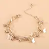 Moda de joyería nueva transfronteriza personalidad dulce pulsera de bola de mariposa conjunto de joyería de doble capa con borla de temperamento simple