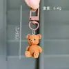 Lindo Oso de Peluche Sentado Tridimensional de Colores Llavero Colgante para Bolso Colgante Pequeño para Coche Regalo para Mejor Amiga Venta al por Mayor