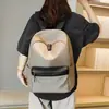 Mochila simple de color liso estilo japonés al por mayor del fabricante para ocio al aire libre, mochila de viaje de gran capacidad, mochila escolar para estudiantes