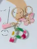 Suministros del Fabricante Llaveros con Flores Secas Prensadas 26 Letras del Alfabeto Inglés Llaveros con Borla de Mariposa Charms para Bolsos de Mujer