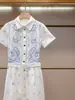 Vestido de Verano Nuevo de Alta Gama para Mujer Estilo Francés Delgado Bordado Hueco de Manga Corta de un Solo Botón en Shenzhen Nanyou