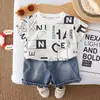 Conjunto de Verano para Niños 2026 Nuevo Estampado de Letras para Niños Manga Corta Ropa Fresca de Verano Elegantes Pantalones Cortos de Mezclilla para Bebé Conjunto de Dos Piezas