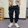 Macacão de bolso múltiplo estilo americano para primavera e outono, masculino, retrô, preguiçoso, marca de moda Ruan Shuai, calças casuais largas com amarração no tornozelo