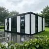 Casa contenedor de bloques de color con puerta de entrada de cristal grande, adecuada para alojamientos en zonas escénicas, campamentos al aire libre y vida móvil
