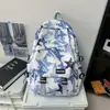 Mochila moderna com graffiti para homens, adequada para alunos do ensino fundamental, médio e universitário; Mochila de viagem estilosa e de grande capacidade para mulheres