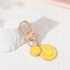 Llavero de cara sonriente transfronterizo aleación gotas de aceite coloridas oro expresión irregular accesorios colgantes para bolso universal