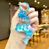 Nuevo llavero de muñeca de delfín con arena movediza relleno de aceite, colgante para mochila, decoración para bolso de pareja, regalo pequeño para venta al por mayor