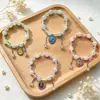 Nuevos y exquisitos pulseras de cristal con cuentas para niños y estudiantes con lindos gatos y perros, populares pulseras culturales y creativas para niñas, al por mayor