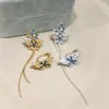 Diseño Europeo y Americano Transfronterizo de Clip para Oreja con Borla de Flor de Mariposa con Goteo de Aceite de Circonita, Brazalete para Oreja sin Perforación, Pendientes Elegantes para Mujer