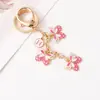 Llavero de Mariposa con Goteo de Aceite Versátil de Moda Llavero de Mariposa con Flor Colgante para Bolso de Mujer Regalos Pequeños Exquisitos Venta al por Mayor