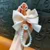 Llavero Creativo Nuevo Lazo Perla Lindo Colgante para Bolso de Mujer Nudo de Tela Colgante Cubierta para Audífonos Regalo Venta al por Mayor