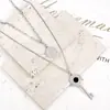 Cadena de suéter de acero de titanio hip hop de doble capa apilada, colgante de llave redonda con marca incrustada de diamantes, accesorios de personalidad femenina, todo a juego avanzado