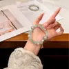 Pulsera de Hilo Plateado Original Natural Vintage Gris Lunar de la Luna con Borla de Lirio del Valle de Personalidad Fresca y Única
