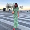 Moda Femenina Europea y Americana Vestido Verde con Estampado en Forma de Abanico, Venta Caliente en Aliexpress, Estampado Hueco, Espalda con Lazo, Corte Entallado, Vestido Largo