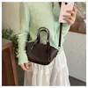 Bolsa de mão tecida de cor sólida de nicho transfronteiriça bolsa cesta de vegetais bolsa feminina 2026 novo estilo da moda versátil bolsa de ombro único transversal
