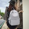 Mochila de color sólido de gran capacidad 2023, nueva mochila de estilo coreano para mujer, mochila de escuela secundaria para hombre, mochila de viaje para estudiantes universitarios.