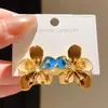 Aretes de flor de oro de 14 quilates chapado con circonita cúbica, vintage, elegantes y refinados, que exudan una estética lujosa y de alta gama