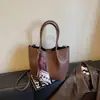Bolso de mano de cuero suave con estampado de lichi minimalista transfronterizo, bolso cubo de lujo retro de otoño para mujer, bolso de hombro de nicho, bolso cruzado
