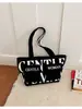 Estilo europeu e americano transfronteiriço, diretamente da fábrica de origem: nova bolsa de lona com letras estampadas, adequada para estudantes usarem na aula, para fazer compras ou como bolsa de ombro ou de axila