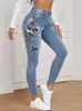 Jeans europeos y americanos personalizados para mujer, marca de moda urbana de tendencia, patrón floral bordado, color liso, corte ajustado, pantalones elásticos para mujer
