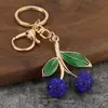 El llavero de cereza más vendido en AliExpress, simple y elegante, accesorio colgante de moda estilo ins para bolso de viajero