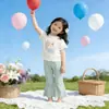 Ropa Infantil Coreana 2026 Verano Nuevo Estilo Tops de Manga Corta para Niñas y Pantalones de Campana Color Sólido Elástico Casual Dulce Conjunto de Dos Piezas