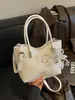 Bolso tejido de nicho de alta gama nuevo para primavera y verano, bolso cubo, bolso tipo empanada, bolso de axila simple y elegante de alta gama para mujer
