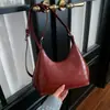 Bolso Cruzado de Hombro Único con Colgante Texturizado Color Sólido Casual Estilo Coreano Verano 2026 Nuevo Elegante Bolso Dumpling para Mujer