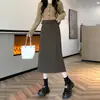 Falda de lana negra de longitud media en línea A con abertura trasera para mujer, nueva falda casual de cintura alta adelgazante Otoño 2026