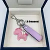 Lindo caballito moderno versátil top de cuero de vaca colgante de llavero de metal para hombres y mujeres, estilo pareja versión coreana llavero