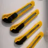 Cuchillo de utilidad al por mayor del fabricante Comercio exterior Cúter de oficina Cúter de papel Cúter de pared Cúter de caja Hoja de utilidad portátil