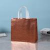Bolsa no tejida bolsa de regalo transfronteriza en stock suministro precio grande excelente revestida aluminizada bolsa de compras láser