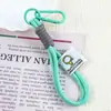 Nuevo Llavero de Mochila con Combinación de Colores Cordón Mosquetón Colgante de Muñeca Cadena para Teléfono Móvil Lanyard de Peluche Cuerda para la Muñeca