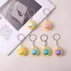 Agujero de spot caja ciega de música muñeca accesorios pequeños huevo Sanrio kulomi dios original llavero pequeño regalo colgante