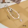Nuevo colgante de manzana y mariposa con cuentas hecho a mano para teléfono, con un toque de alta gama, charm de cadena doble para bolso, cadena para colgar el teléfono, regalo